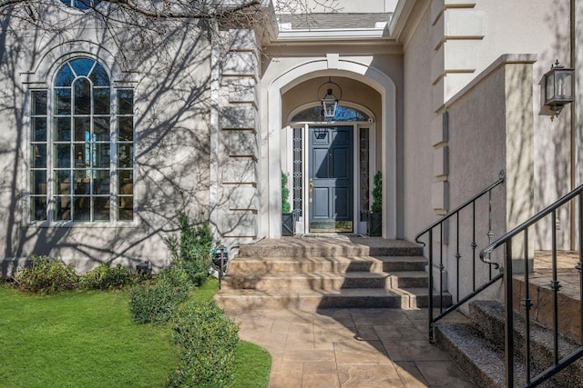 133 Brighton Close, Nashville, TN 37205 - view of exterior entry featuring stucco siding, stone siding, and a lawn