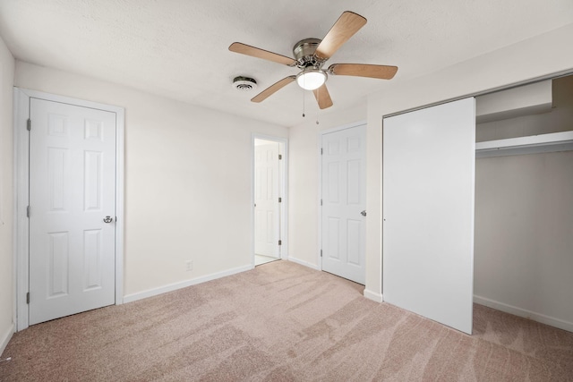 unfurnished bedroom featuring carpet, baseboards, and ceiling fan