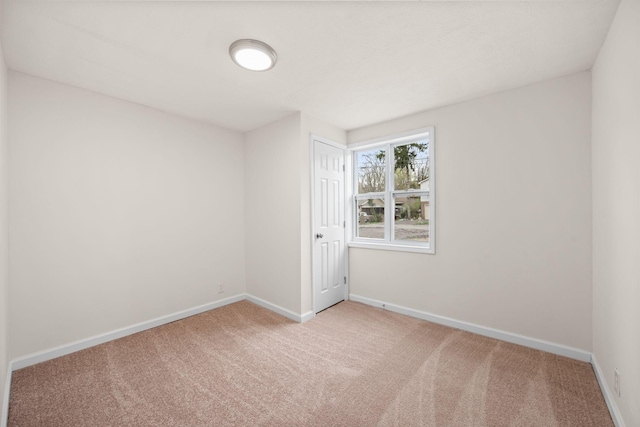 carpeted spare room with baseboards