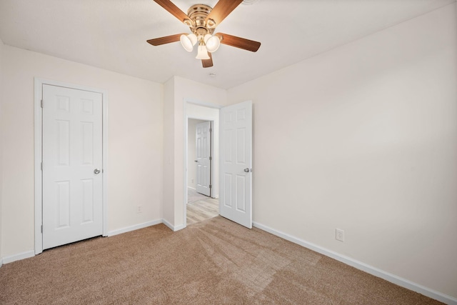 unfurnished bedroom featuring carpet floors, baseboards, and ceiling fan