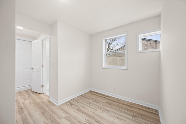 unfurnished bedroom with light wood finished floors and baseboards