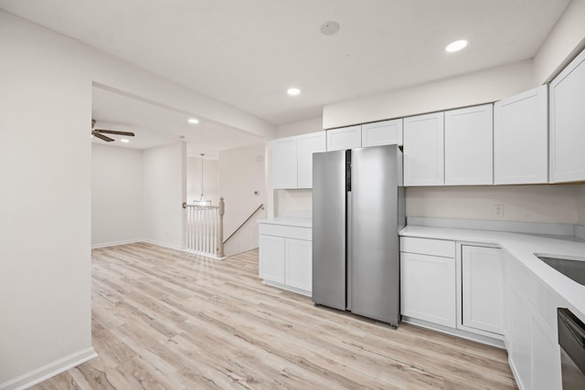 kitchen with stainless steel appliances, light countertops, light wood-style flooring, white cabinetry, and recessed lighting