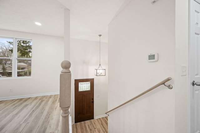 entryway with light wood-style flooring and baseboards