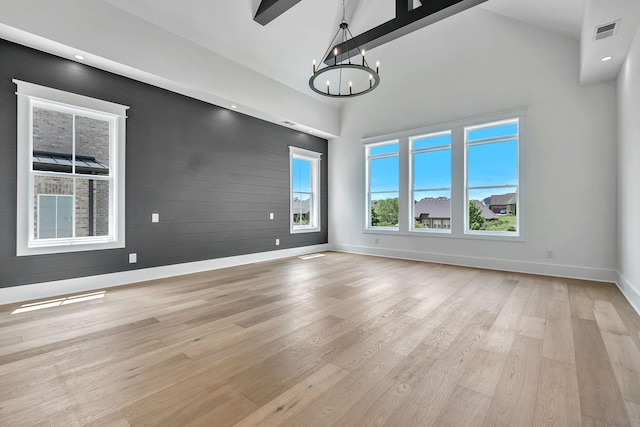 1018 Keeneland Dr, Gallatin, TN 37066 - unfurnished dining area with a chandelier, light wood-type flooring, high vaulted ceiling, baseboards, and wooden walls
