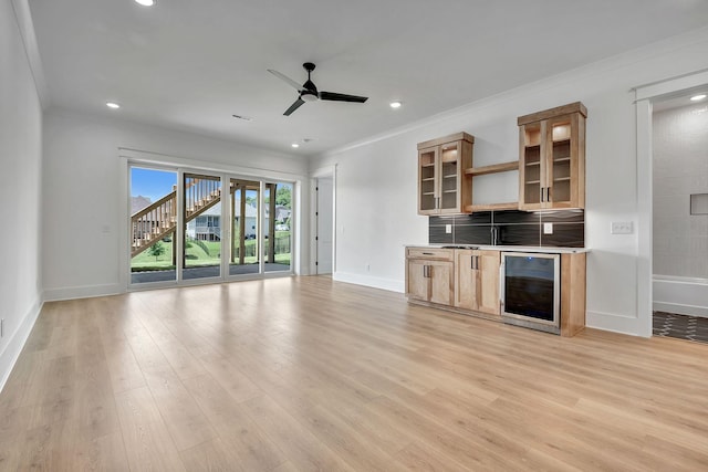 1018 Keeneland Dr, Gallatin, TN 37066 - unfurnished living room with beverage cooler, ornamental molding, baseboards, a ceiling fan, and light wood-type flooring
