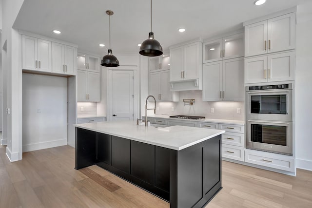1018 Keeneland Dr, Gallatin, TN 37066 - kitchen featuring stainless steel appliances, a sink, baseboards, a kitchen island with sink, and recessed lighting