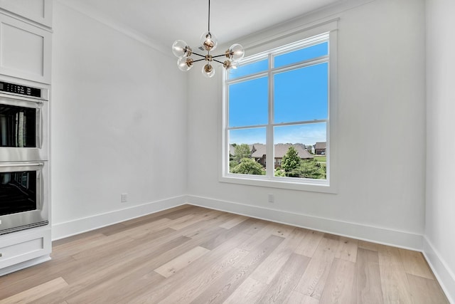 1018 Keeneland Dr, Gallatin, TN 37066 - unfurnished dining area with light wood-type flooring, a chandelier, and baseboards