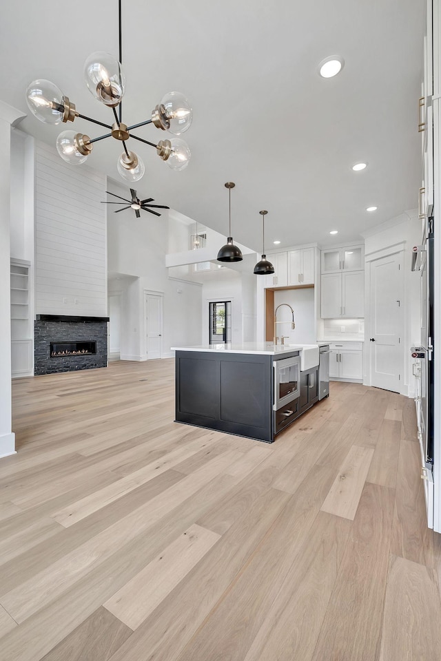 1018 Keeneland Dr, Gallatin, TN 37066 - kitchen with a sink, white cabinets, stainless steel appliances, open floor plan, and light wood-style floors