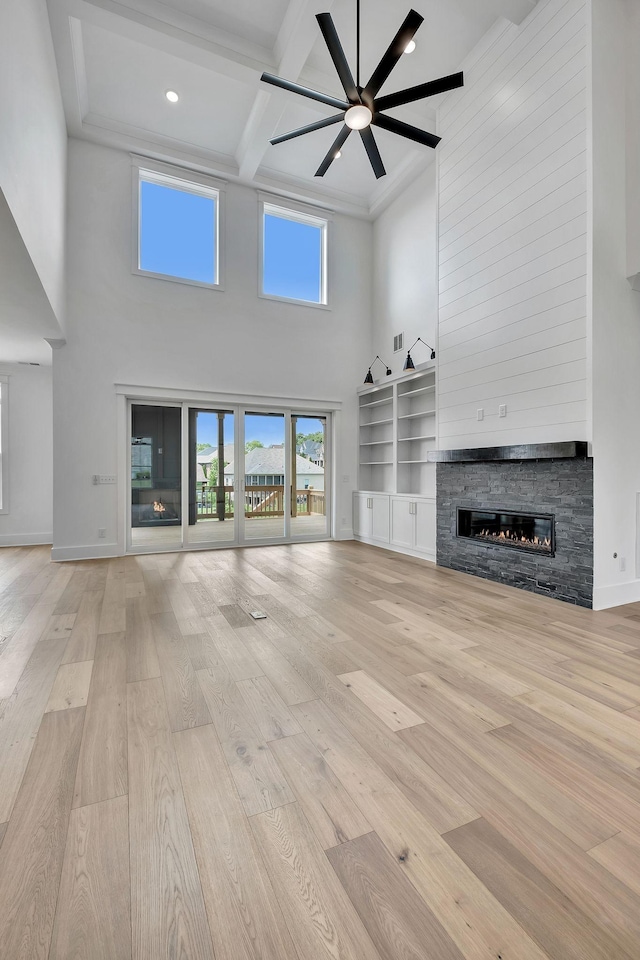 1018 Keeneland Dr, Gallatin, TN 37066 - unfurnished living room featuring a high ceiling, coffered ceiling, a fireplace, light wood-type flooring, and beam ceiling