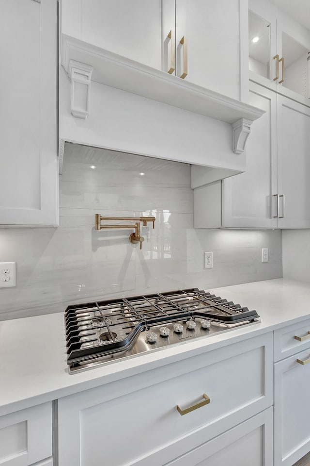 1018 Keeneland Dr, Gallatin, TN 37066 - kitchen featuring tasteful backsplash, white cabinets, light countertops, and stainless steel gas cooktop