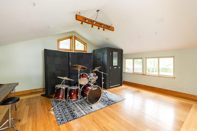 playroom with lofted ceiling, wood finished floors, and baseboards