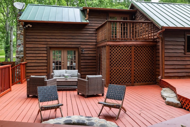 wooden terrace featuring french doors and outdoor lounge area