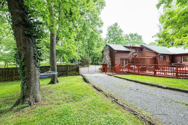 view of yard with a deck and driveway
