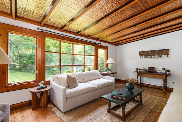 living room featuring plenty of natural light, wood finished floors, and baseboards
