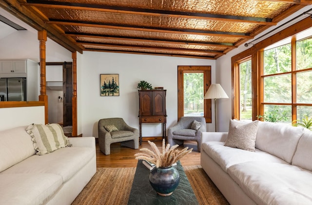 living area with wood finished floors and lofted ceiling