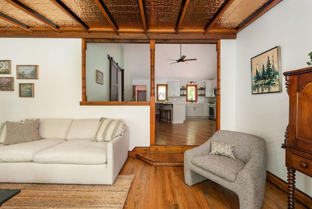 living room with wood finished floors and ceiling fan