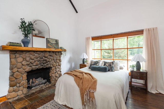 bedroom with wood finished floors, high vaulted ceiling, a fireplace, and beamed ceiling
