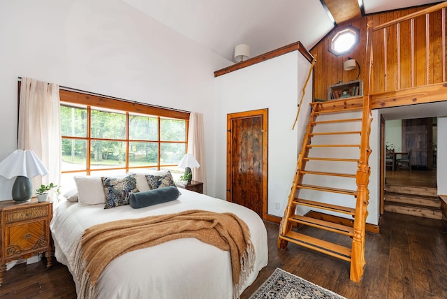 bedroom with high vaulted ceiling and wood-type flooring