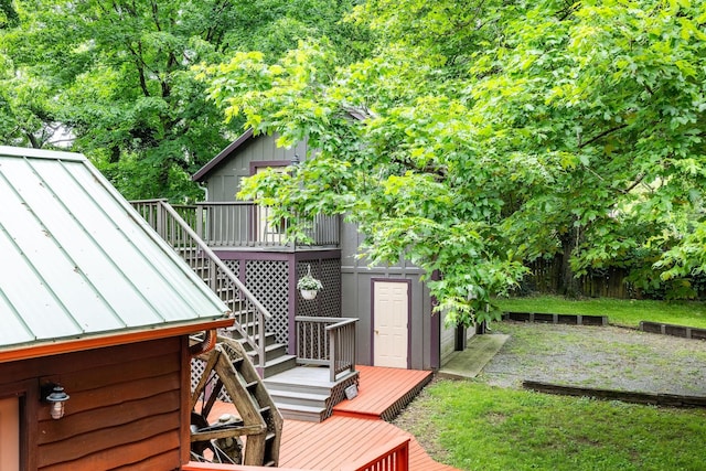 wooden deck with stairway and a lawn