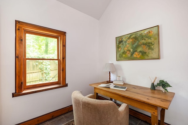 office area with lofted ceiling, tile patterned flooring, and baseboards
