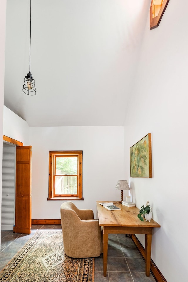 home office with baseboards and lofted ceiling
