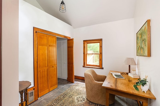 office space featuring vaulted ceiling and baseboards