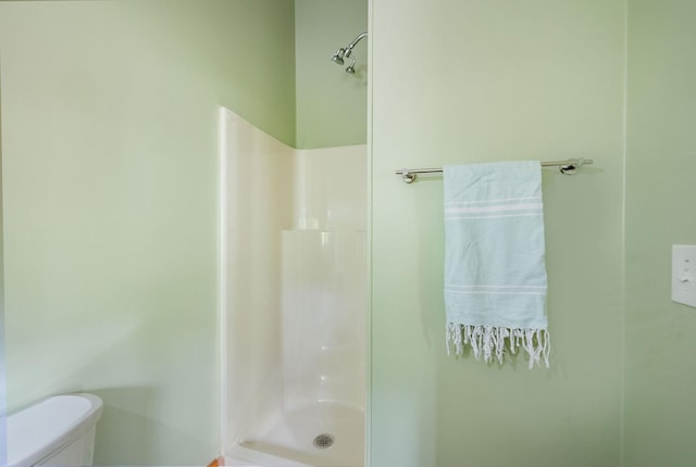 bathroom with walk in shower and toilet
