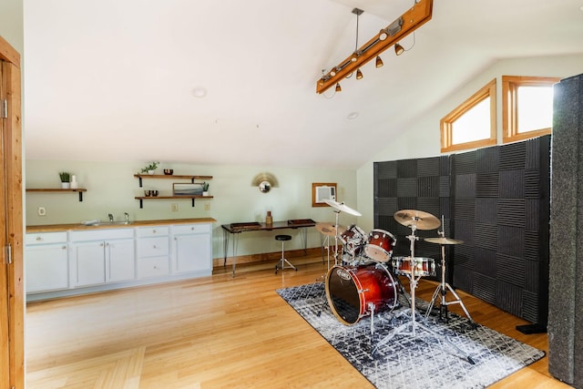 rec room featuring light wood-style flooring and lofted ceiling