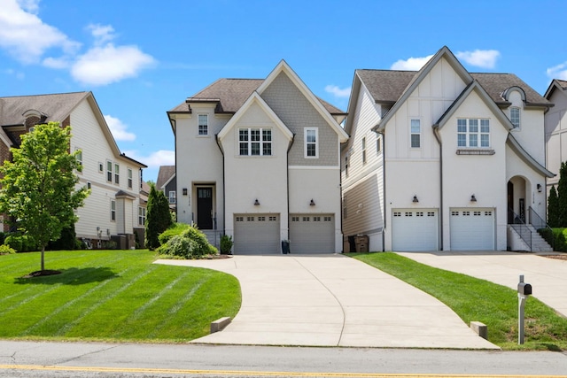 view of front of house with an attached garage, concrete driveway, and a front lawn