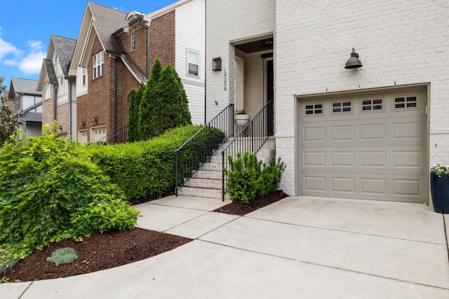view of front of house featuring concrete driveway and brick siding