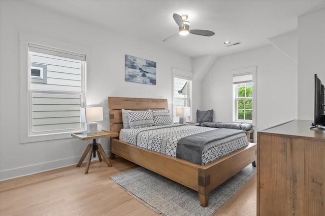 bedroom featuring baseboards, light wood-style flooring, and ceiling fan