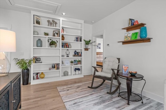 living area featuring light wood finished floors and baseboards