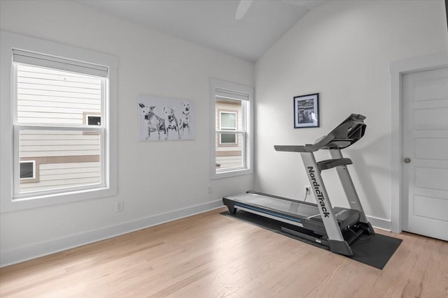 workout room featuring wood finished floors, baseboards, and lofted ceiling