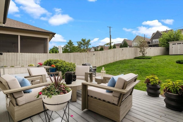 deck with an outdoor living space, a storage shed, and an outbuilding