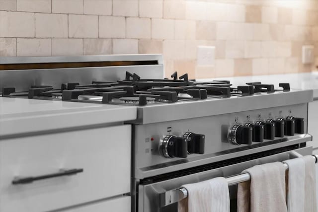 kitchen view of backsplash and gas range