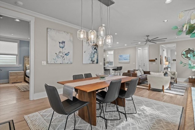 dining room with ornamental molding, recessed lighting, baseboards, ceiling fan, and light wood finished floors