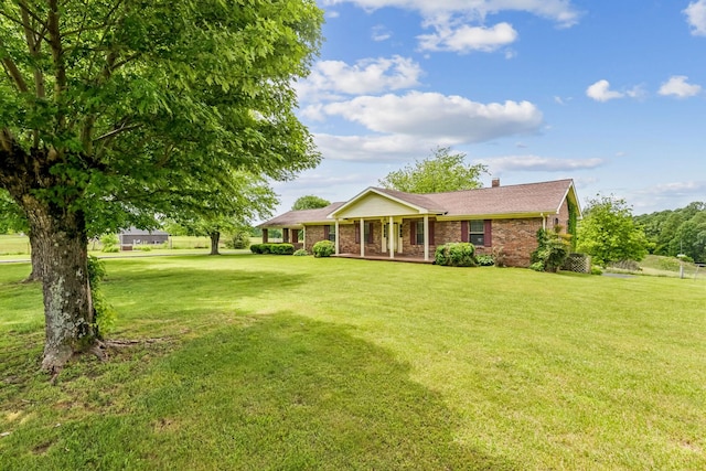 5245 Galen Rd, Lafayette, TN 37083 - ranch-style house with covered porch, a front lawn, a chimney, brick siding, and roof with shingles