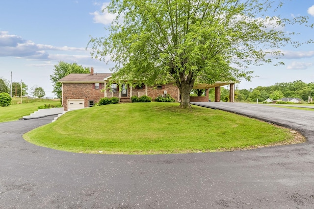 5245 Galen Rd, Lafayette, TN 37083 - view of front of property featuring driveway, a front lawn, a garage, a chimney, and brick siding