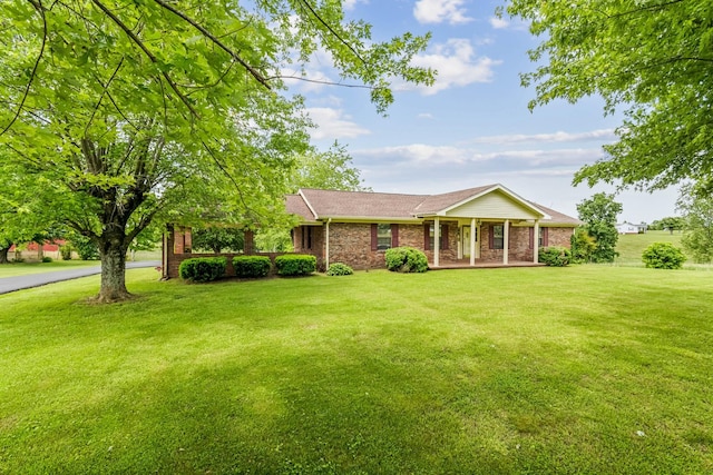 5245 Galen Rd, Lafayette, TN 37083 - view of front of house featuring a porch, a front lawn, and brick siding