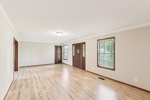 5245 Galen Rd, Lafayette, TN 37083 - foyer entrance with crown molding, light wood-style floors, plenty of natural light, and baseboards