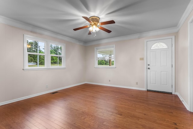 foyer entrance featuring wood finished floors, a ceiling fan, baseboards, and ornamental molding