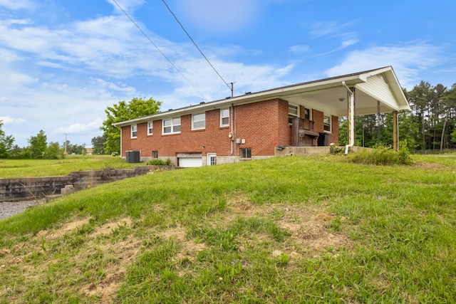 view of home's exterior featuring brick siding, an attached garage, and central AC