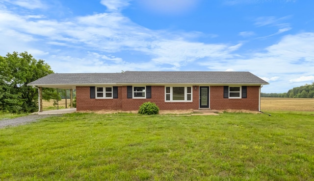single story home with gravel driveway, a front lawn, brick siding, and a carport