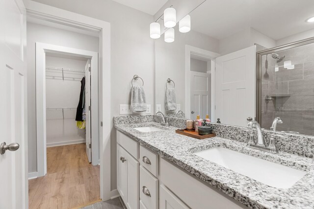 895 Industrial Dr, Old Hickory, TN 37138 - bathroom with a stall shower, wood finished floors, a spacious closet, double vanity, and baseboards