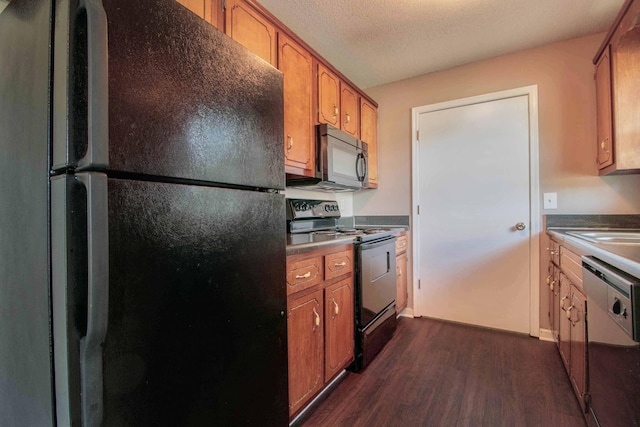 587 Joshua Dr, Clarksville, TN 37042 - kitchen with stainless steel range with electric cooktop, freestanding refrigerator, dark wood-style flooring, dishwasher, and brown cabinetry