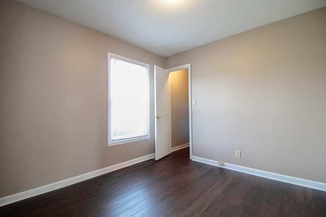 587 Joshua Dr, Clarksville, TN 37042 - spare room featuring baseboards and dark wood finished floors