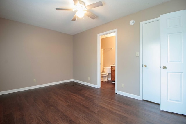 587 Joshua Dr, Clarksville, TN 37042 - unfurnished bedroom with dark wood-style flooring, baseboards, connected bathroom, and ceiling fan
