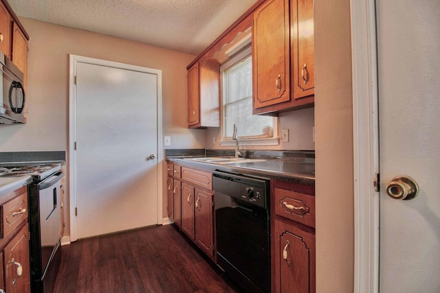 587 Joshua Dr, Clarksville, TN 37042 - kitchen with black appliances, a sink, dark wood finished floors, a textured ceiling, and brown cabinetry