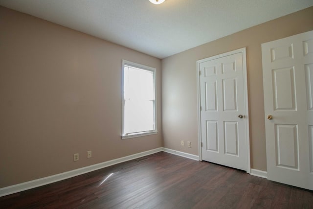 587 Joshua Dr, Clarksville, TN 37042 - unfurnished bedroom featuring dark wood-type flooring and baseboards