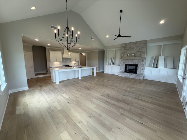 2301 Rockweather Ct, Murfreesboro, TN 37128 - unfurnished living room with a ceiling fan, a fireplace, high vaulted ceiling, light wood-style floors, and a sink